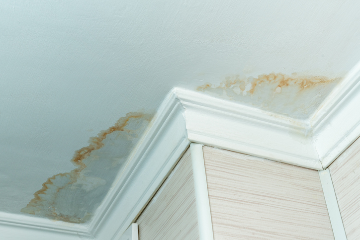 Neighbors have a water leak, water-damaged ceiling, close-up of a stain on the ceiling