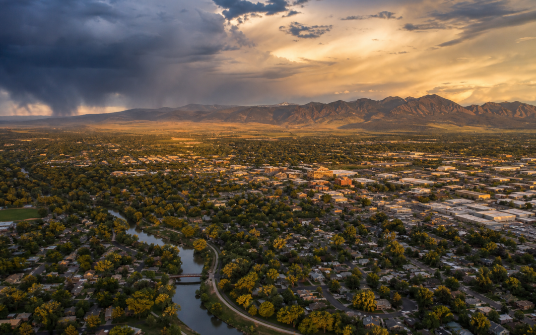 Aerial view of Longmont Colorado residential neighborhoods with the Front Range mountains and approaching storm clouds